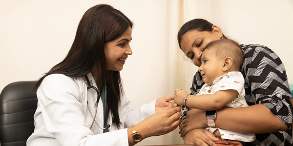 Pediatrician examining a young child at Janani Hospital, Vijayapura